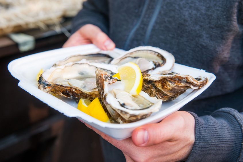 Man with Plate of Oysters on Folly Beach, SC