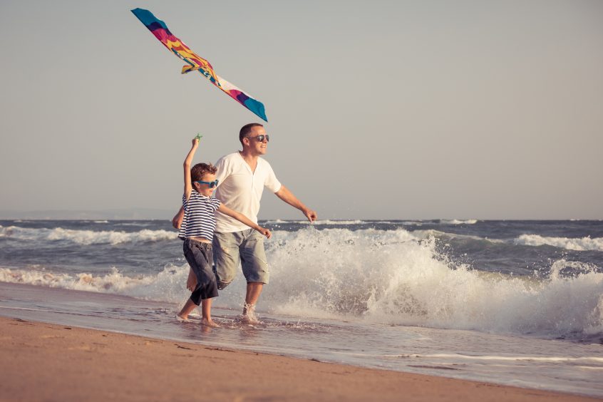 Father and Son Flying a Kite on Folly Beach, South Carolina